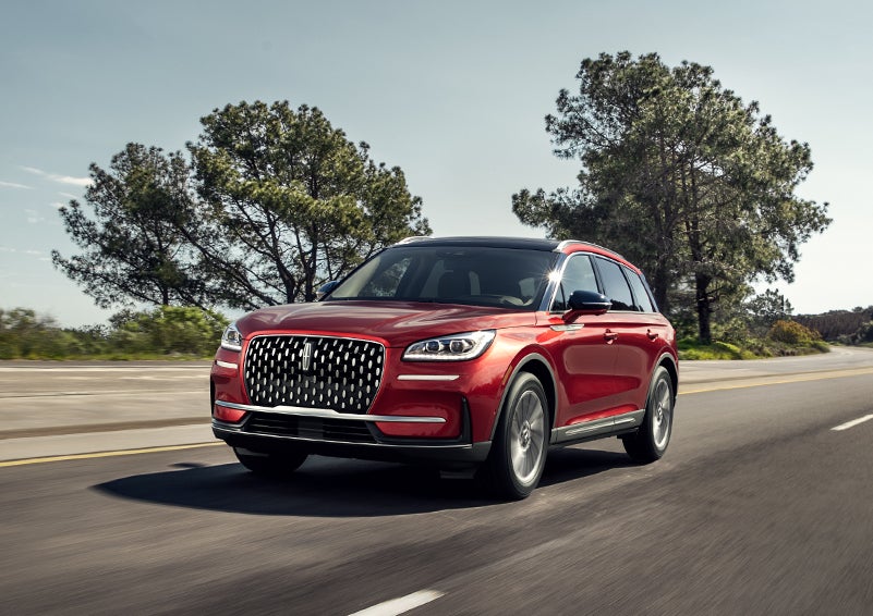 A 2023 Lincoln Corsair® SUV is shown being driven on a country road. | Baldwin Lincoln in Covington LA