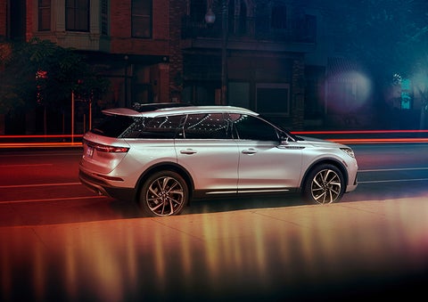 A 2023 Lincoln Corsair® SUV is shown parked in the city at night. | Baldwin Lincoln in Covington LA