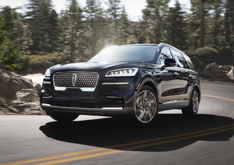 A Lincoln Aviator® SUV is being driven on a winding mountain road | Baldwin Lincoln in Covington LA