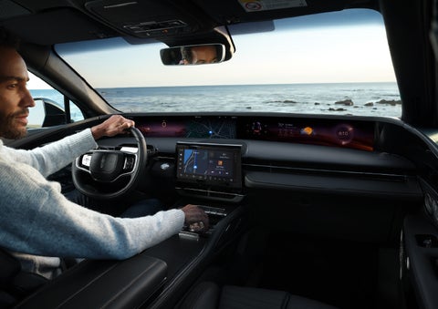 A driver of a parked 2024 Lincoln Nautilus® SUV takes a relaxing moment at a seaside overlook while inside his Nautilus. | Baldwin Lincoln in Covington LA