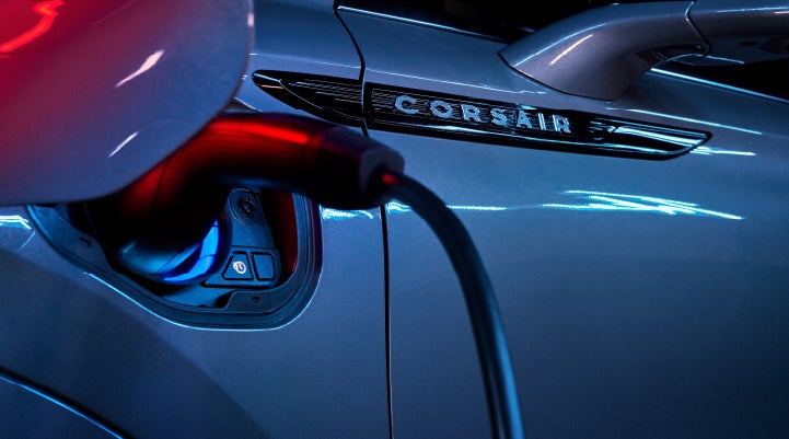A charger plugged into the charging port of a 2024 Lincoln Corsair® Plug-in Hybrid model. | Baldwin Lincoln in Covington LA