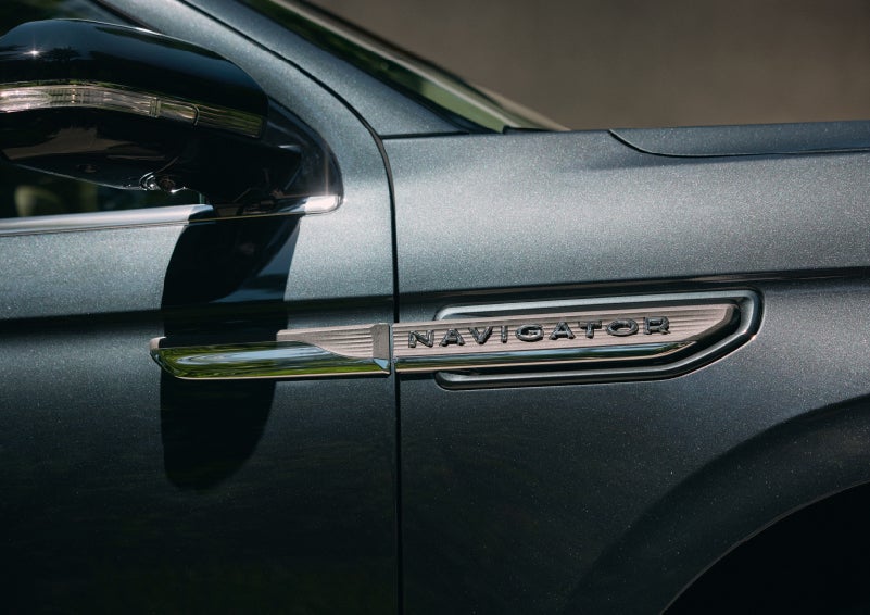 The nameplate badge near the passenger sideview mirror on 2022 Lincoln Navigator in Flight Blue shows off geometric design | Baldwin Lincoln in Covington LA