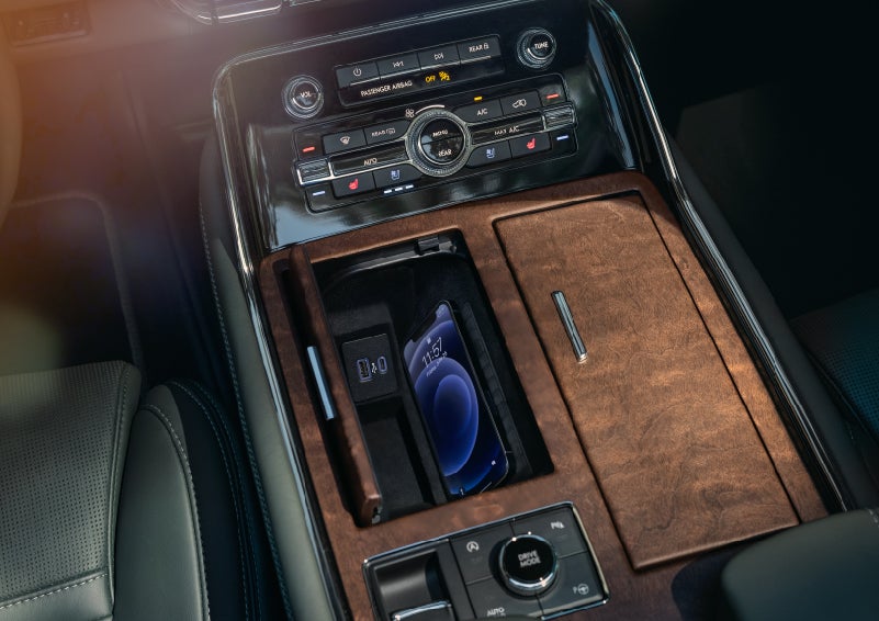 A smartphone is charging on the wireless charging pad in the front center console cubby | Baldwin Lincoln in Covington LA