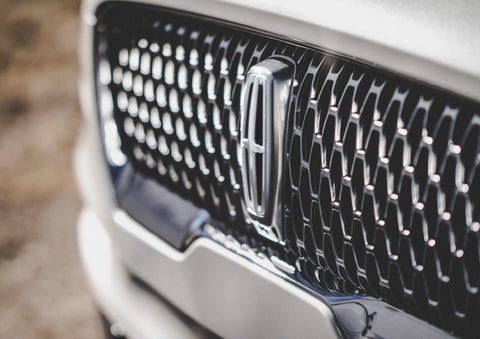 The grille of the 2024 Lincoln Aviator® Reserve model with an eye-catching repeated field of Lincoln Star logo shapes | Baldwin Lincoln in Covington LA