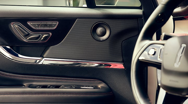 A Revel® audio speaker is shown in the driver’s side door of a 2024 Lincoln Corsair® SUV. | Baldwin Lincoln in Covington LA