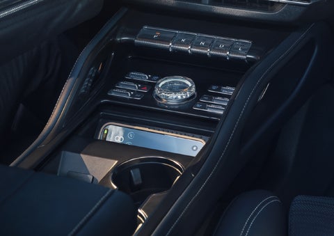 A smartphone is shown charging in the wireless charging pad. | Baldwin Lincoln in Covington LA
